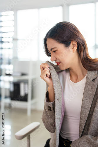 Bilde på lerret Asian female office lady got problem of stinky and disgusting on clothes