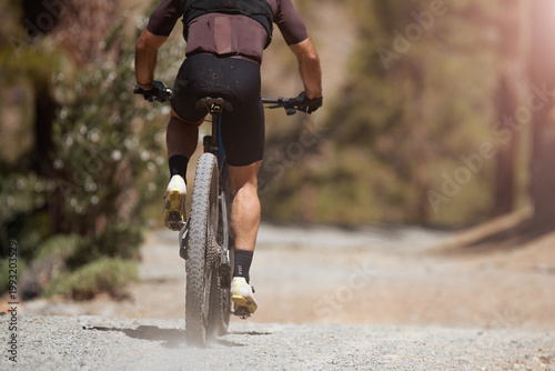 Mountain biking man riding on bike in summer mountains forest landscape. Sport fitness motivation and inspiration in beautiful inspirational landscape