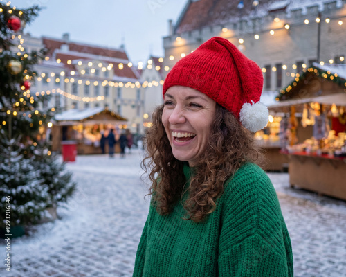 Beautiful woman wearing a red Santa's hat, happy and smiling woman, Christmas festive time