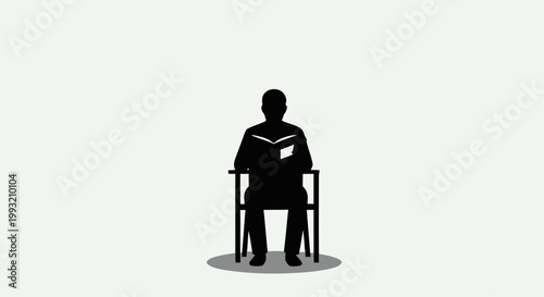 Silhouette of a person sitting and reading a book in a chair.