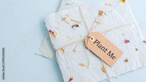 Plantable seed paper with flowers and tag, eco-friendly stationery, biodegradable card design, sustainable handmade greeting, recycled paper product, wildflower seeds, natural craft