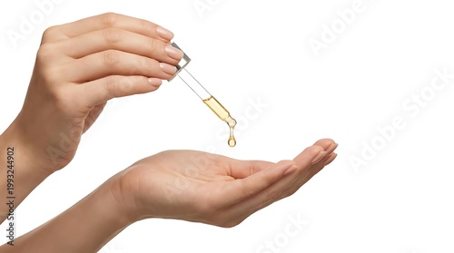 A hand holding a dropper with a yellow liquid over an outstretched palm