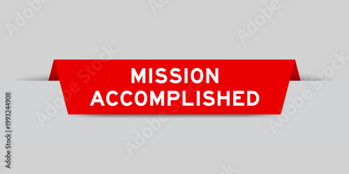 Red color inserted label with word mission accomplished on gray background
