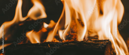 Closeup panoramic view of burning fire in a stone fireplace