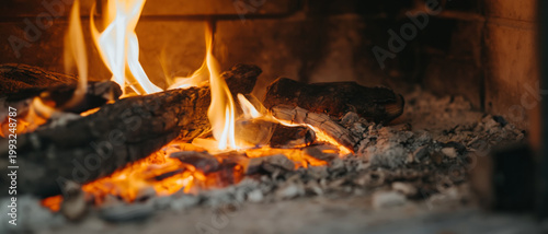 Closeup panoramic view of burning fire in a stone fireplace