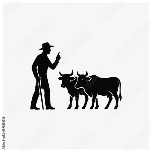 Silhouette of a herdsman pointing towards or supervising a group of cattle.