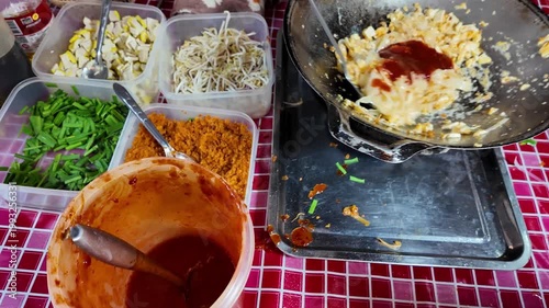 Adding Sauce to Pad Thai in Wok with Fresh Ingredients 4K Thai Street Food