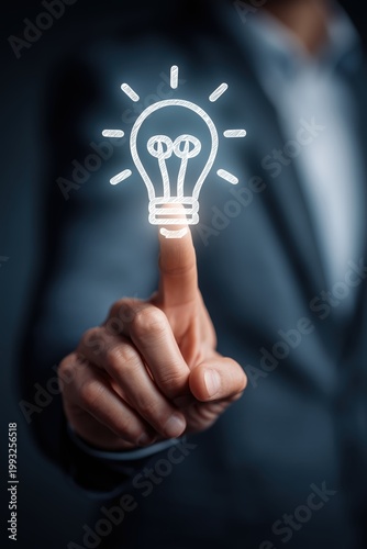 Businessman touching a light bulb icon on a transparent screen, representing the concept of idea and innovation.