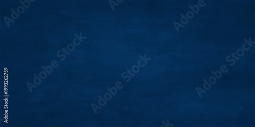 A vintage dark blue denim fabric texture with a rough grunge pattern provides a stylish material surface for a fashion backdrop or wallpaper design