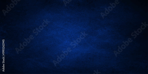 A dark blue vintage denim fabric texture with a rough grunge pattern on an old cloth material canvas surface provides a weathered textile wallpaper design backdrop