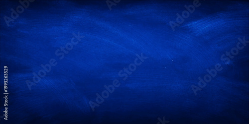 Abstract dark blue background design featuring a grunge texture of smoke and storm clouds over a deep sea night sky with motion light and lightning