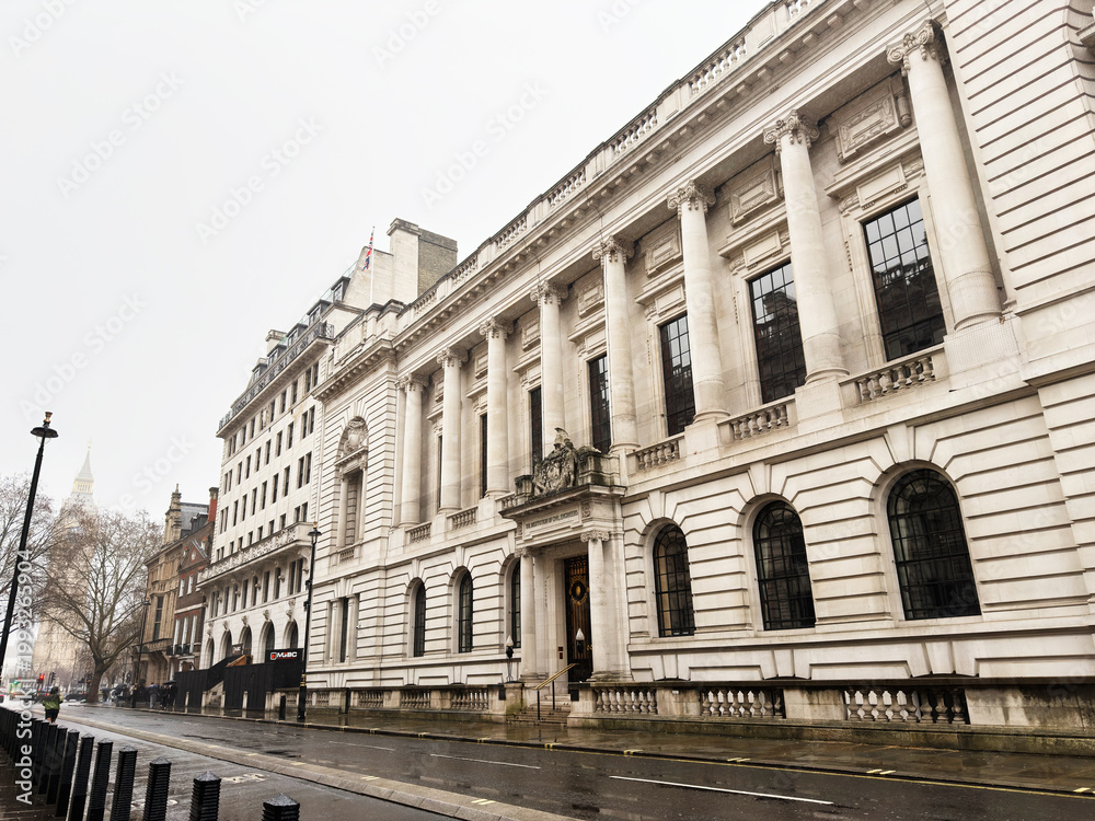 Obraz premium Neoclassical government Institution of Civil Engineers building with grand columns on a rainy London, UK street, historic urban architecture