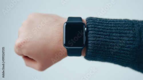 Password security, Person wearing a black smartwatch on the wrist with a dark sweater sleeve visible.
