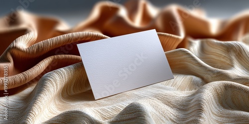 Blank card surrounded by satin ribbons and silk scraps in various cream tones 