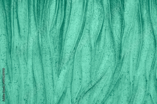 Teal green abstract texture with flowing organic waves suggesting motion, depth and natural erosion.
