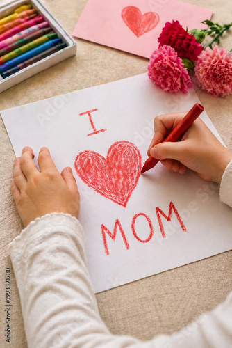 Close-up of child hands drawing heart on paper, handmade Mother’s Day gift concept, soft natural light, emotional and warm scene.
