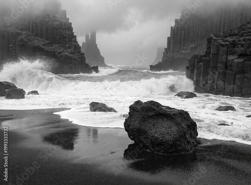 Reynisfjara black sand beach with basalt columns disappearing into fog, powerful waves, monochrome tones, moody atmosphere, cinematic fine art photography, shot on medium format camera, ultra realisti