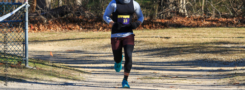 Runner Participating in a Race on a Path in the Park