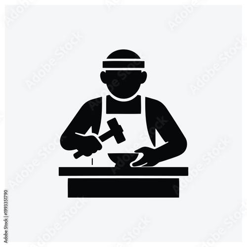 Silhouette of a carpenter or craftsman using tools at a workbench.