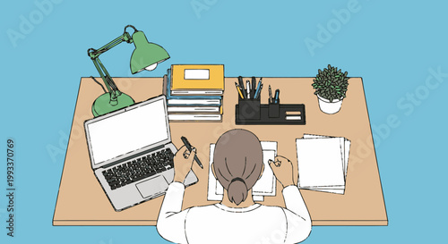 Person working diligently at a desk with laptop and books.