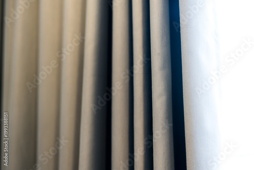 Grey curtain background. Rolls of coarse fabric