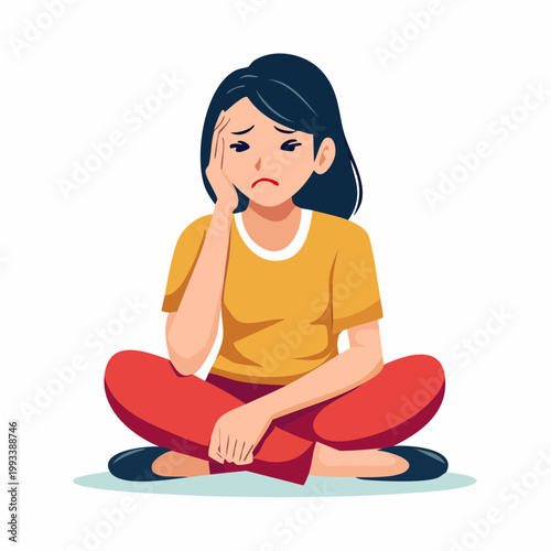 Woman sitting cross-legged with hand on forehead, looking sad