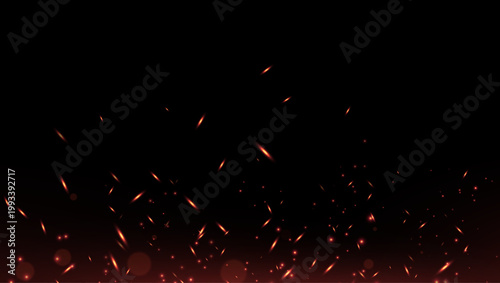 Smoldering embers on a black background. Background with fire sparks. Fire sparks with a bright glow and dynamic heat effect.