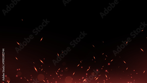 Smoldering embers on a black background. Background with fire sparks. Fire sparks with a bright glow and dynamic heat effect.