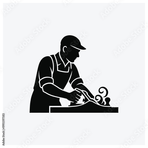 Silhouette of a sculptor working with stone or clay on a table