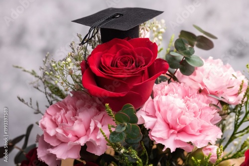 Graduation Flowers With a Cap on Display in a Bright Arrangement With Pink an...