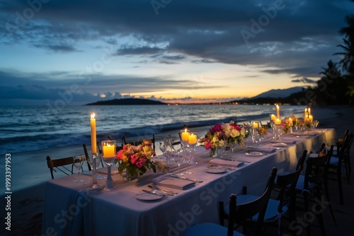 Sunset Dinner Setup on a Beach With Candles and Flowers