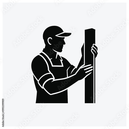 A worker or carpenter using tools on a vertical plank or post.