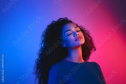 Model Poses in Colorful Lighting With Curly Hair and Closed Eyes in a Studio ...