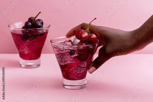 Enjoying Cold Cherry Drinks on a Pink Background in a Bright Setting With Ice...