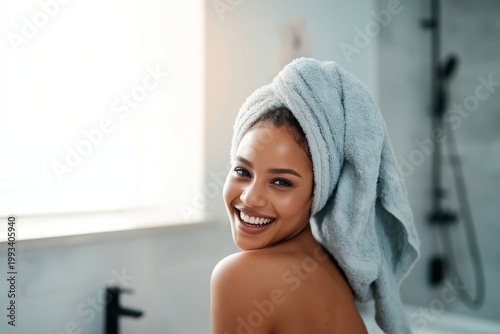 Woman With Towel in Bathroom Smiling at the Camera in Bright Natural Light Du...