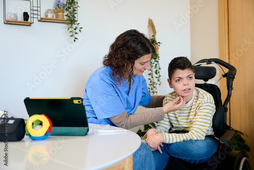 Canvastavla Nurse aiding boy with cerebral palsy in wheelchair