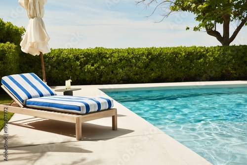 Sunny Day by the Pool With Lounge Chair and Striped Umbrella in a Garden