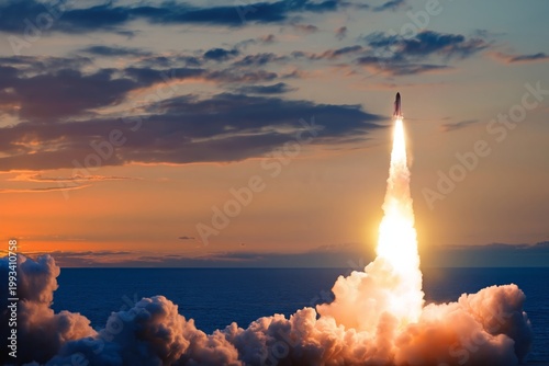 Rocket Launch Over the Ocean During Sunset With Clouds and Smoke Rising High ...