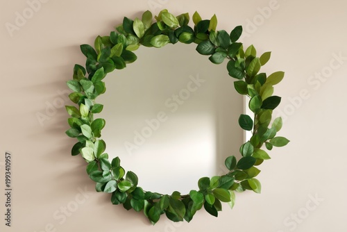 Circular Mirror With Green Leaf Decoration on Wall in Bright Indoor Space