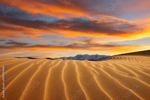 Sand Dunes Reflect Sunlight at Sunset in Desert Landscape With Mountains in B...