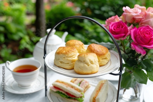 Enjoying Tea Time With Roses and Sweets in a Sunny Garden Setting