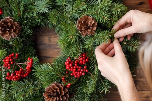 Creating a Festive Wreath With Pine Branches, Berries, and Cones During the H...