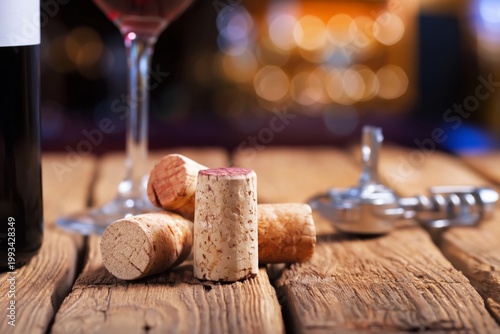 Wine Bottle With Corks and Glass on Wooden Table at a Gathering