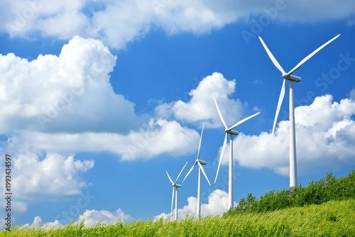 Wind Turbines Spin in the Field Under the Blue Sky With Clouds in the Afternoon