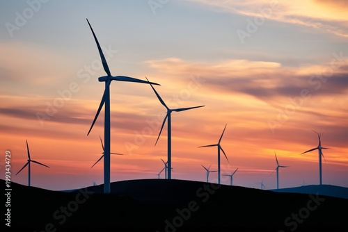 Wind Turbines Turn Against a Colorful Sunset Sky in a Quiet Landscape at Dusk