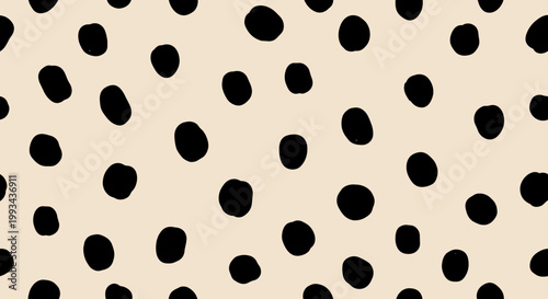 Abstract black polka dot pattern on a light beige background for design