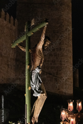 A large crowd gathers at dawn in Avila for the Penitential Via Crucis. The ancient Christ of the Executed statue is paraded along the city walls in a deeply traditional Good 