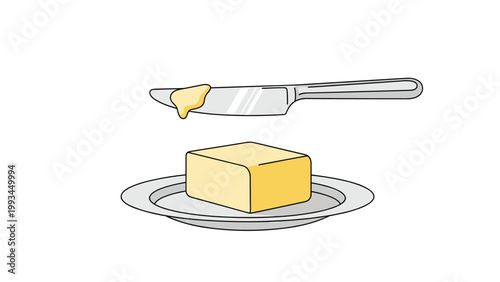 Rectangular pat of yellow butter sitting on a small white plate with a silver butter knife taking a small portion for spreading.
