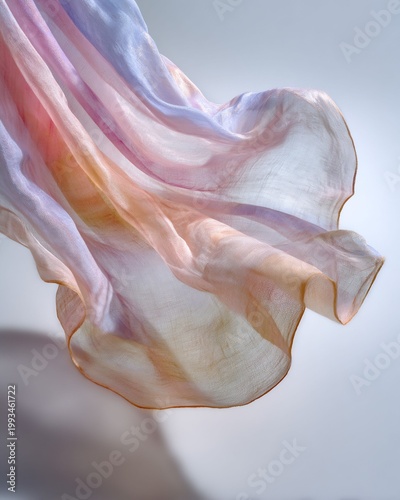 Floating sheer silk fabric in pastel colors flowing through the air