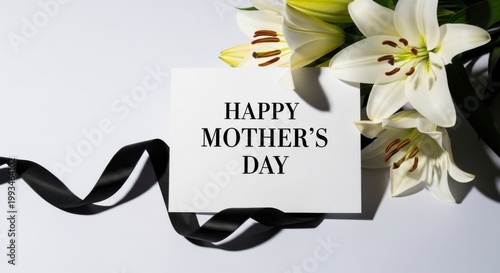 Happy Mother's Day greeting card with white lily flowers, elegant black silk ribbon on white background, minimalist floral celebration still life
